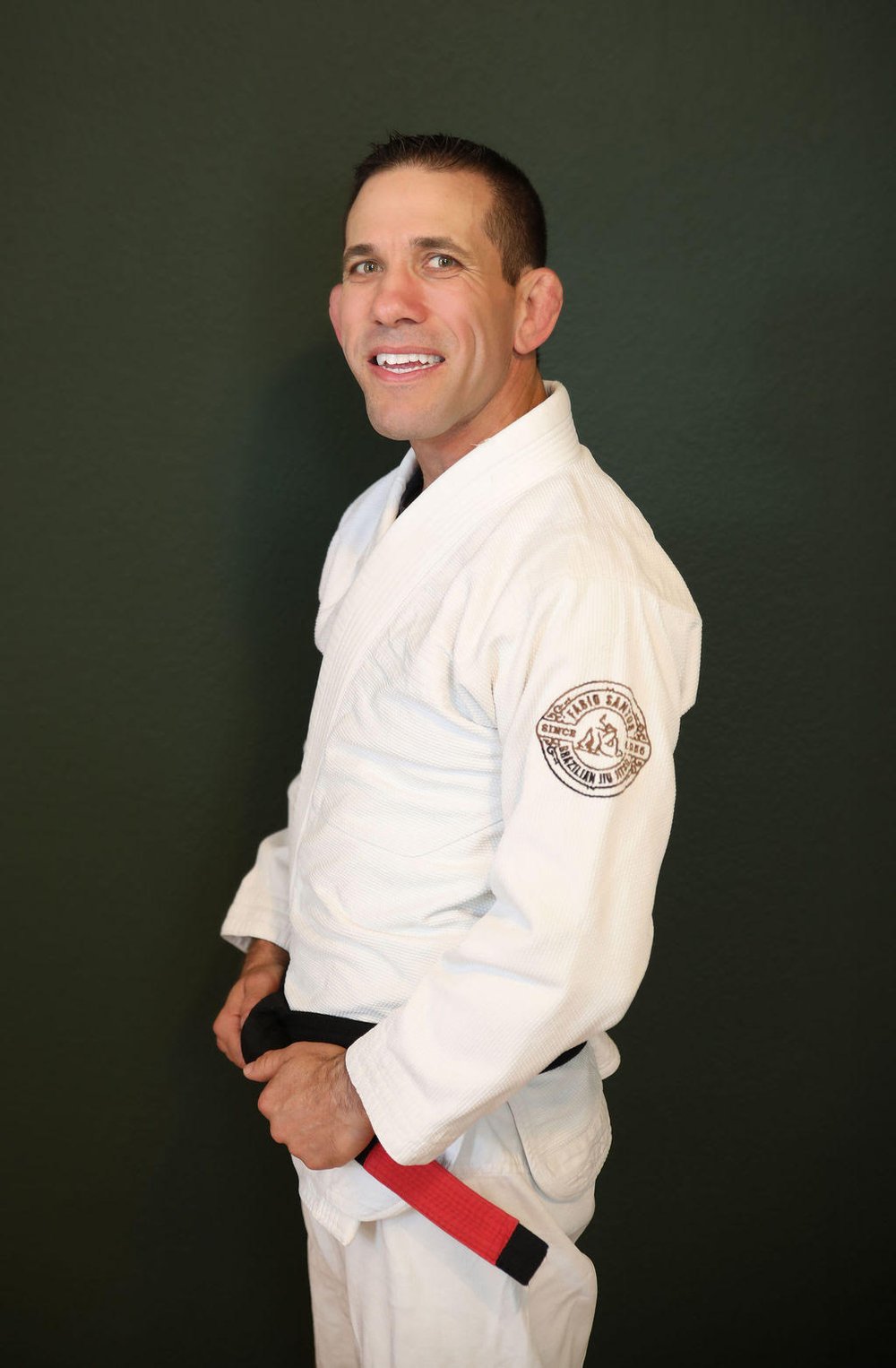 Instructor in a white gi and black belt at Trilogy Martial Arts