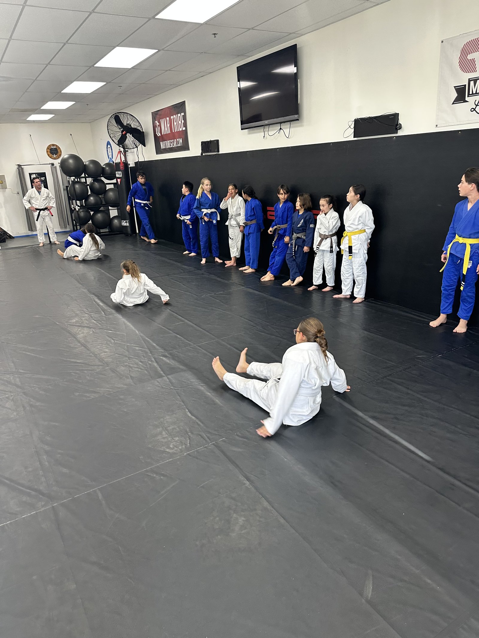 Kids class lined up in gi on the mat at Trilogy Martial Arts, El Cajon