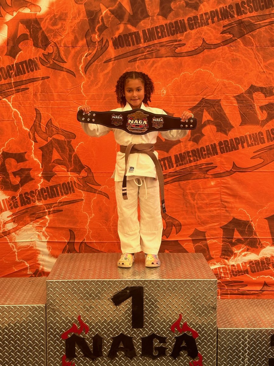 A young Trilogy student on the podium at a NAGA event